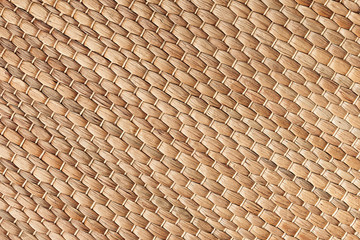 Bamboo woven beige mat handmade background. Wicker wood texture. Diagonal strips.