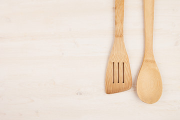 Design concept of mockup of empty wood beige spoons on white wood background.  Copy space. Top view.