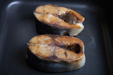 Fried tuna fish on a black pan