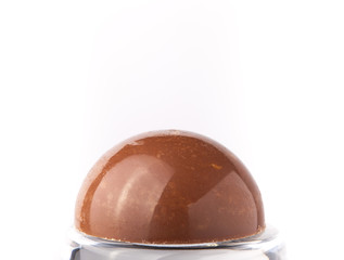 One chocolate candy on a light background