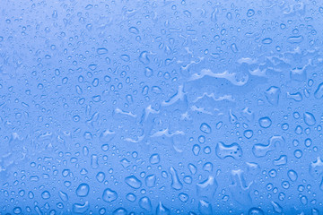 Drops of water on a color background. Blue. Selective focus. Ton