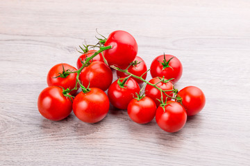 Fresh cherry tomatoes on rustic wooden background