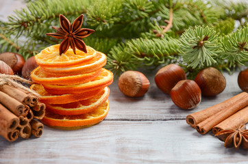 Christmas background with Fir Branches, Nuts, Spices and Dried oranges.