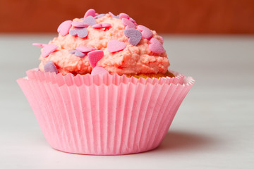 strawberry cupcake with icing sprinkles