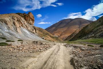 Dirt gravel mountain road through central Tibet