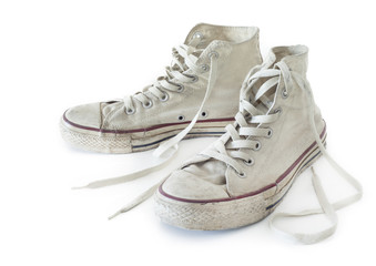 Old white sneakers on white background