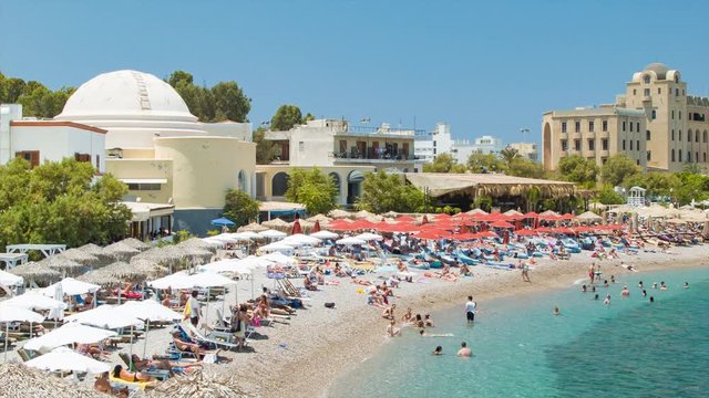 People Enjoying Eli Beach in Rhodes Greece Sunbathing with Umbrellas at Greek Style Resorts in a Mediterranean Summer Setting