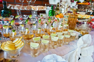 Glasses with lime and tequila at wedding reception