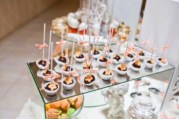 sweet candies and cupcakes on wedding reception