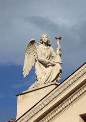 Fototapeta na wymiar Angel statue with candelabra