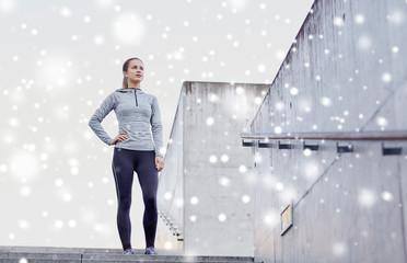 sporty woman standing on in city stairs