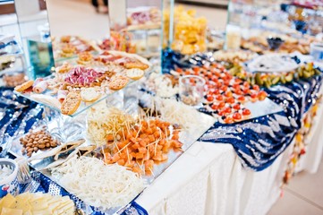 sea table of meat, cheese and snacks on wedding reception