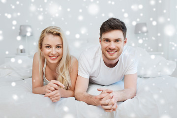 happy couple lying in bed at home