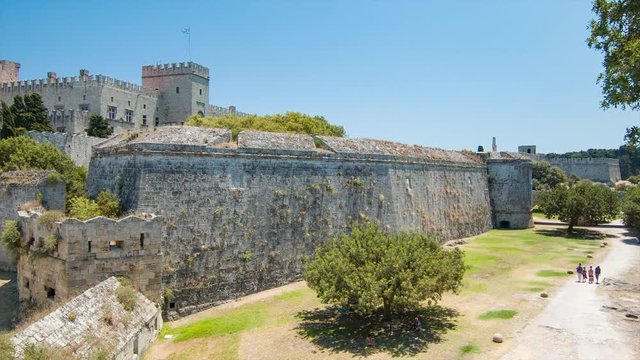 Palace of the Grand Master of the Knights in Rhodes Greece at the Edge of Historical Old Town in the Ancient Greek City with Tourists Visiting the Fortress Walls on a Sunny Day