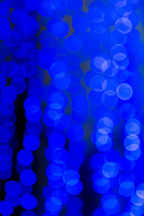 Abstract blurred blue background. The lights of illuminations or lights in a blur. Bokeh and defocusing