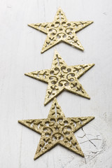 Vintage Christmas stars on white painted wooden background