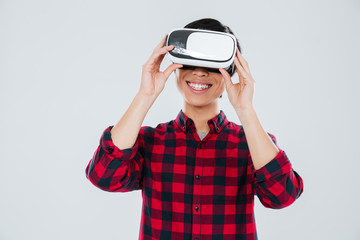 Happy young asian man wearing virtual reality device