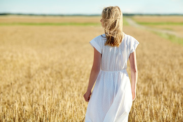 Fototapeta na wymiar young woman in white dress on cereal field