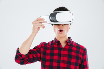 Man wearing virtual reality device while holding phone