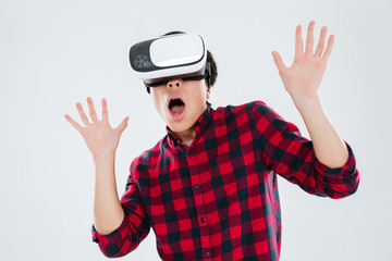 Man wearing virtual reality device and gesturing with hands
