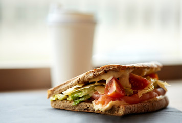 salmon panini sandwich on stone plate at cafe