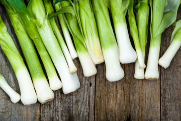 Fresh leeks, green vegetables, farm fresh produce on farmer table