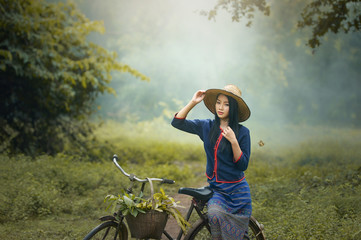 Asian woman wearing traditional thai culture,walking to go home on field,vintage style