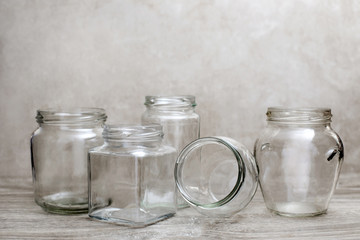empty glass bottle and jars over wood