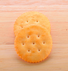 Cookies on the dish with wooden ground.