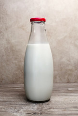glass milk bottle over sepia background