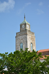 Fototapeta na wymiar Catholic church on the island in France on blue sky background