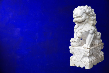 Fototapeta premium Chinese Imperial Lion, also called Guardian Lion on gold wall background