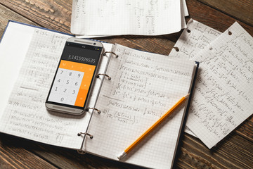 Mathematical equations written in a notebook. Calculator app. © perfectlab