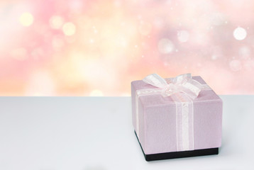 Present box on wooden  table with city view background.