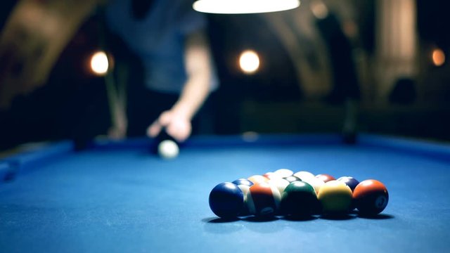 View of billiard's table and man playing snooker
