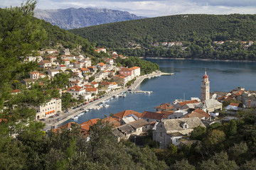 Fototapeta premium Red roofs and white stone houses in deep bay in village Pucisca on island Brac in Croatia