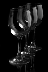 Three elegant wine glasses in a black background.