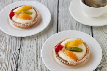 Tartlets with cream and fruits, orange, kiwi, cherry