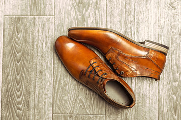 Fashion concept with male shoes on wooden background