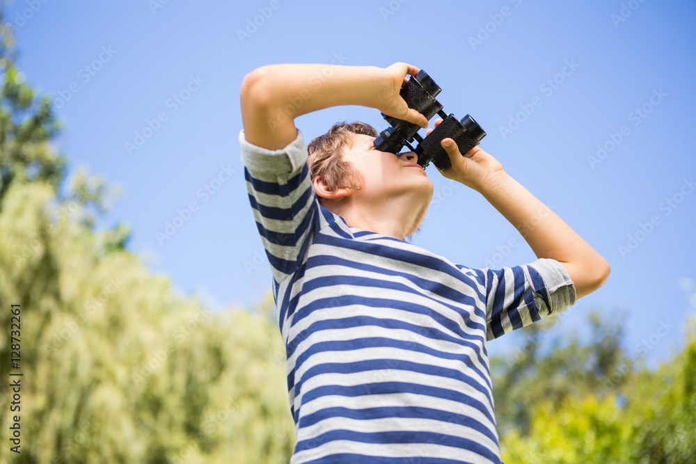 Poster low angle view of a child looking something with binoculars