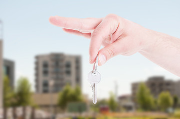 Close-up hand of real estate agent holding key
