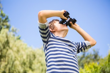 Low angle view of a child looking something with binoculars