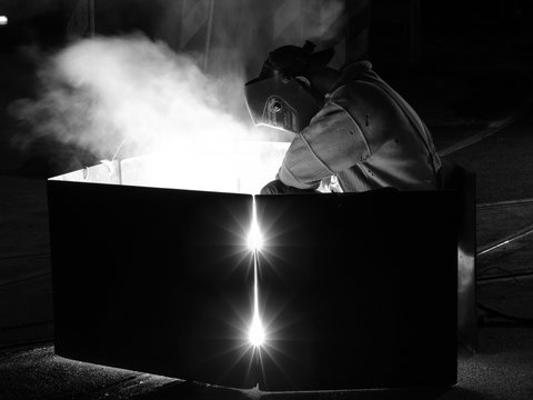 welder on street black and white