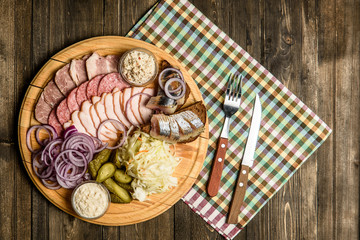 Sausages on the grill pan the wooden background. Top view