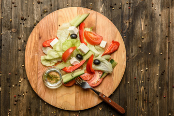 Ingredients of Fresh vegetable salad on olive wood cutting board