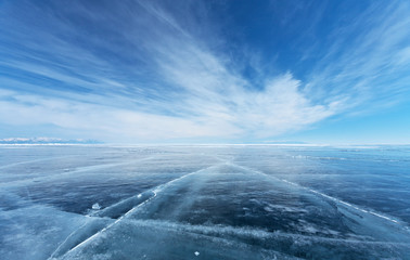 Frozen Lake Baikal. Beautiful stratus clouds over the ice surface on a frosty day. Natural...