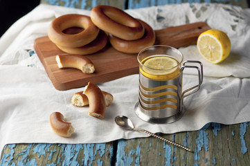 Mug of tea with bagels on a wooden background