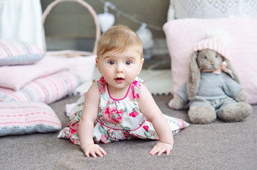 Adorable smiling baby girl crawling