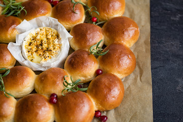 Holiday bread wreath with baked camembert,