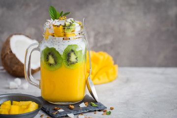 mango,  coconut and chia seeds pudding in glass ja